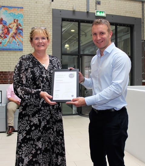 Chris Jarvis, Managing Director, giving the Mental Health First Aider certificate to Caroline Hutchins, Operations Director